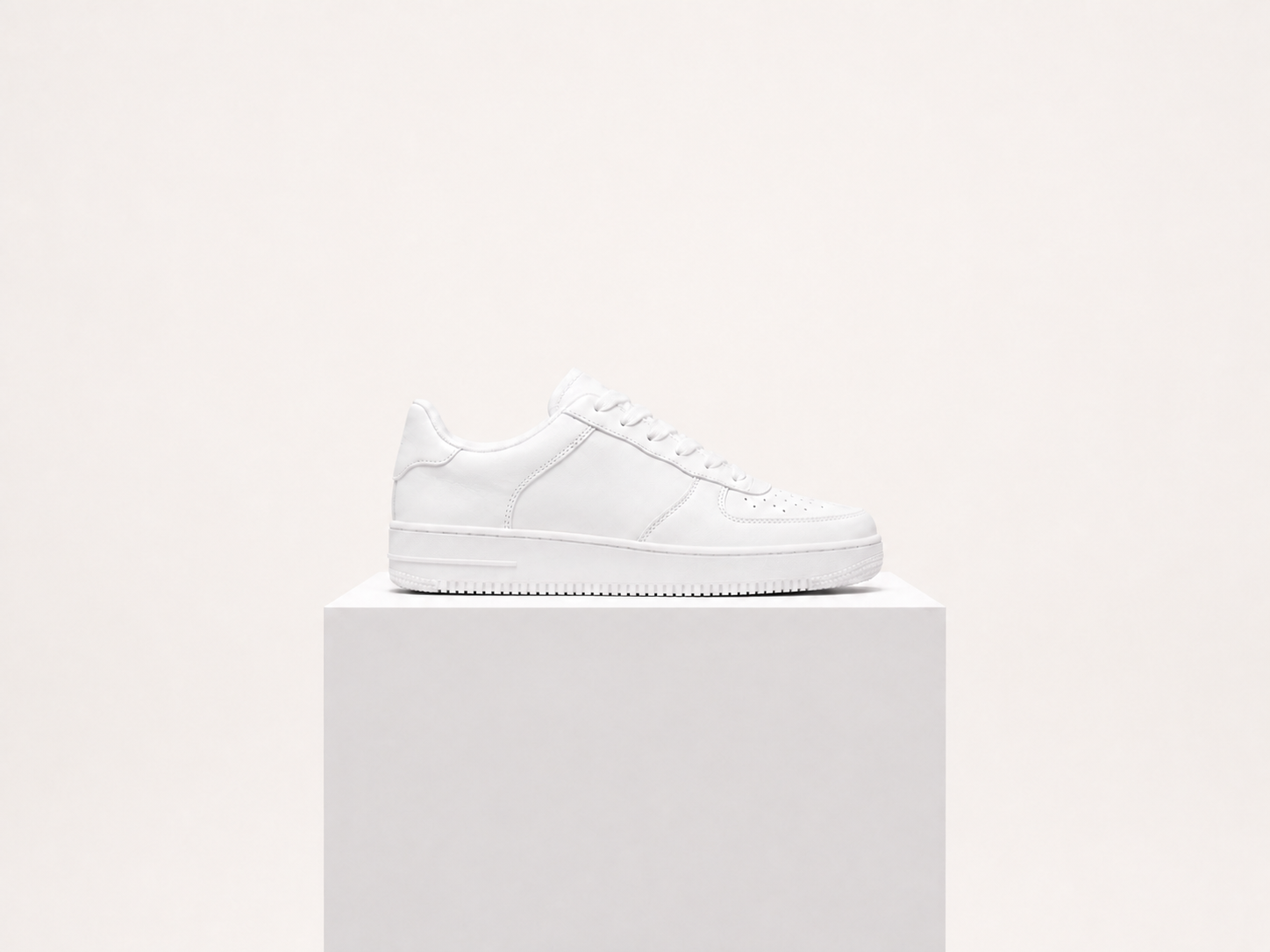 The same white sneaker on a clean studio background after green-screen removal